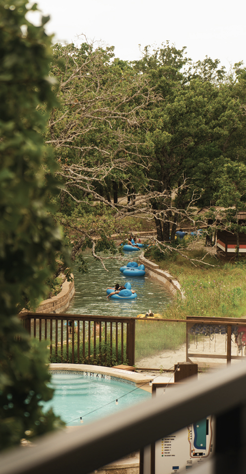 Guests floating along lazy river at resort water park